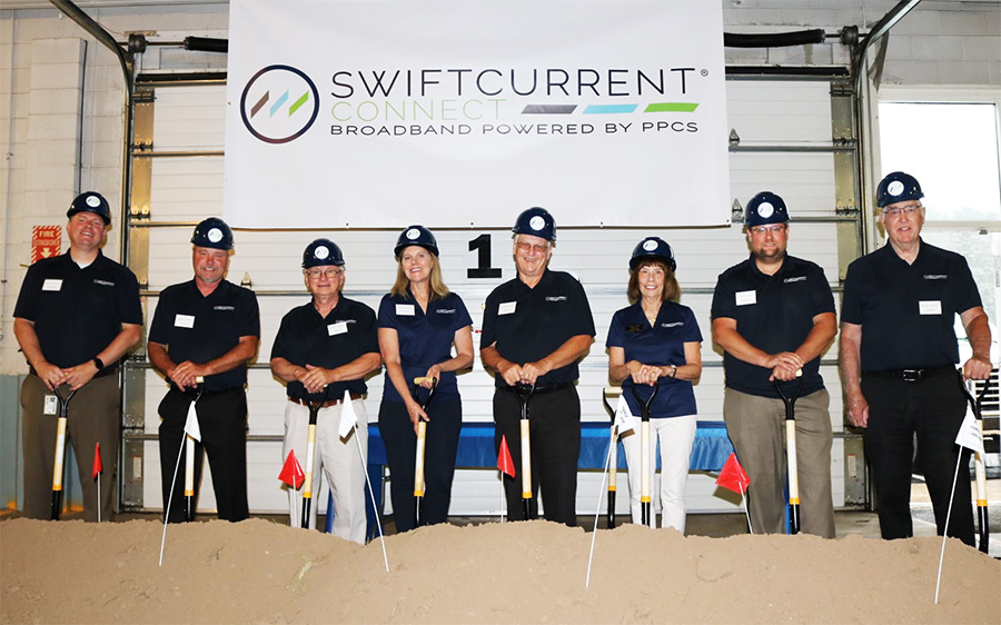 Swift Current Connect employee group photo in warehouse.