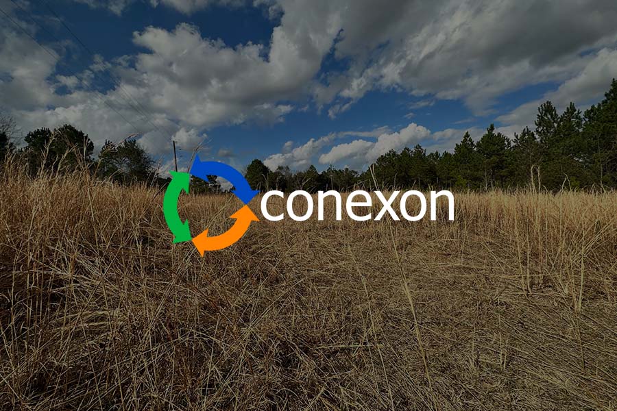 A grassy brown field on a sunny cloudy day with the Conexon logo overtop.