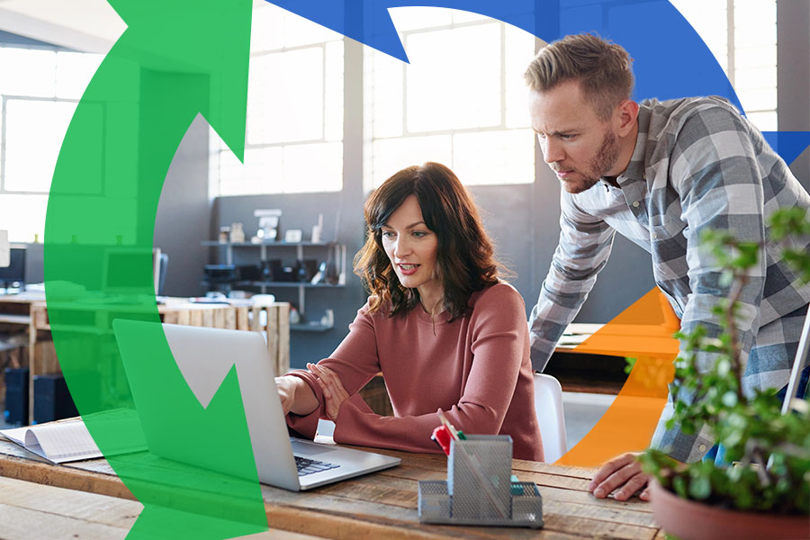 Co workers chat about their work over a laptop with a Conexon icon behind for thumbnail.
