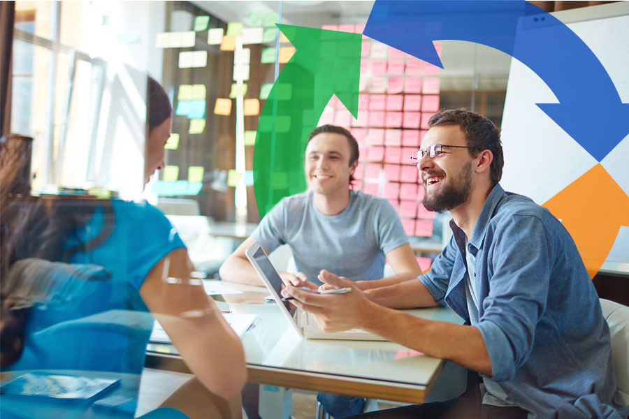 Two men smile over a desk while talking with a woman and a Conexon icon in the background for thumbnail.
