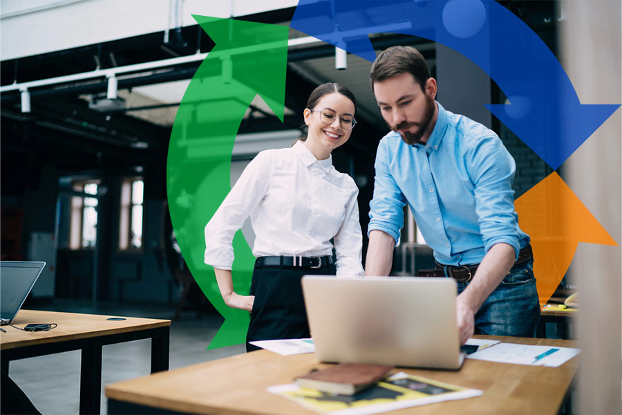 A man and a woman stand talking over a computer in an office with a Conexon icon behind them for thumbnail.