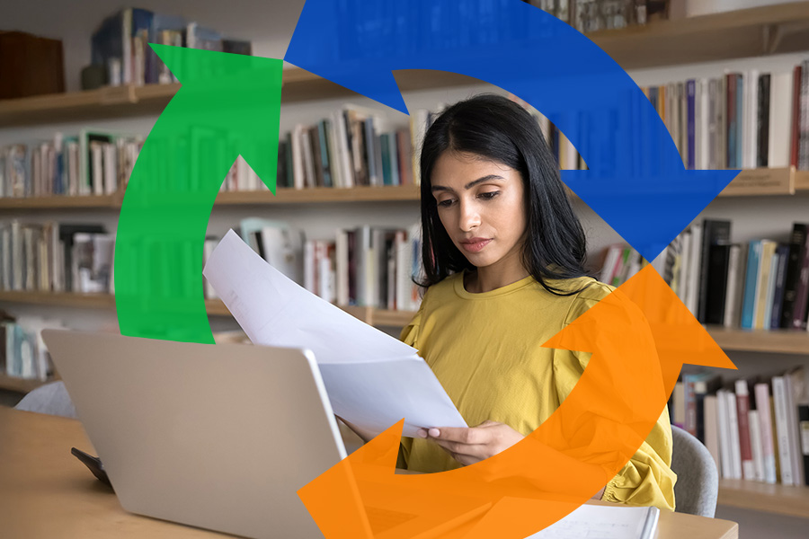 A woman sits behind her desk using her laptop and looking at reports with a Conexon logo behind her for thumbnail.