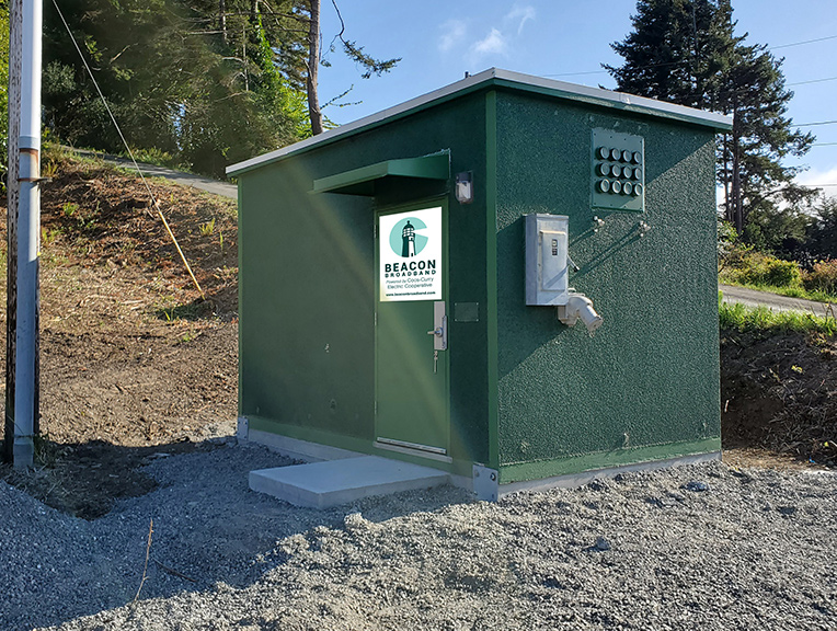 A hub walk-in power box with Beacon logo on door.