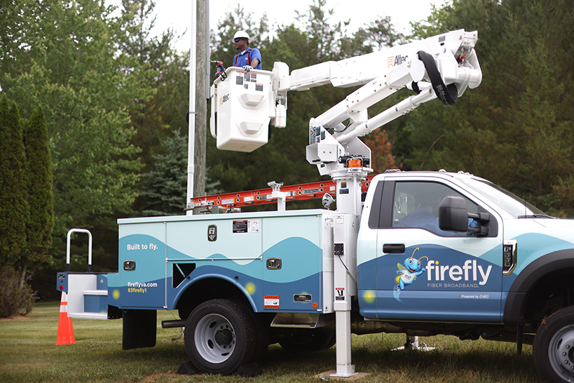 A cherry picker truck with the FireFly logo on it.