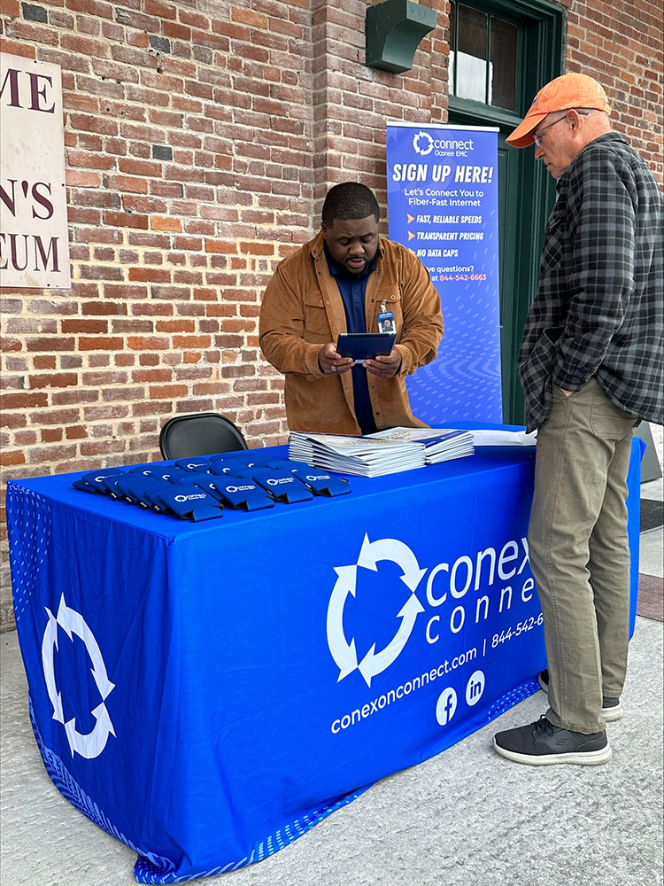 A Conexon Connect booth with an employee interacting with a customer.