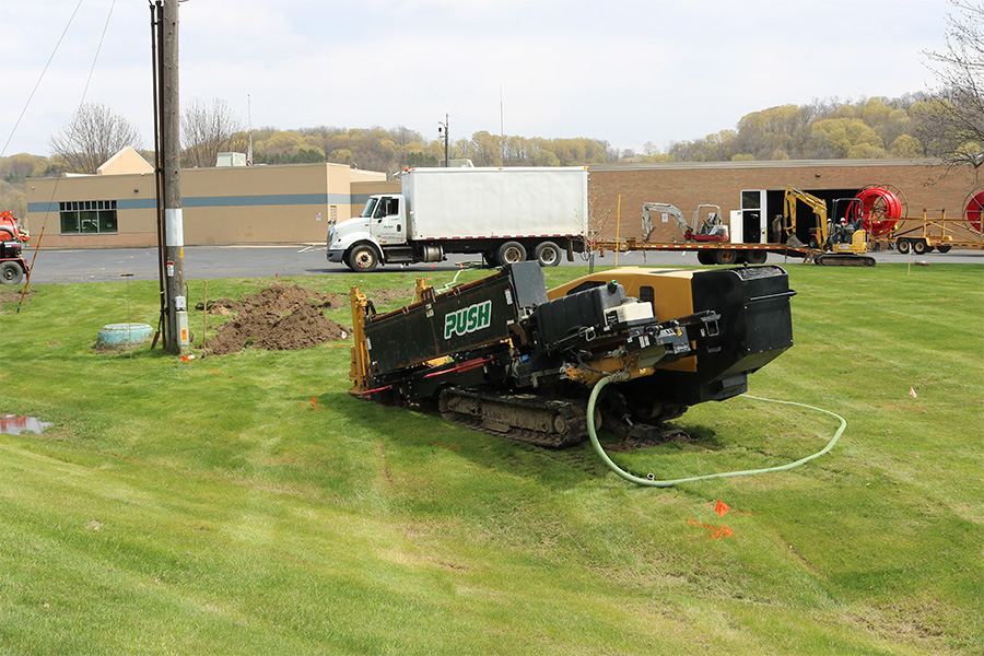 Machines operate in a grassy plain.