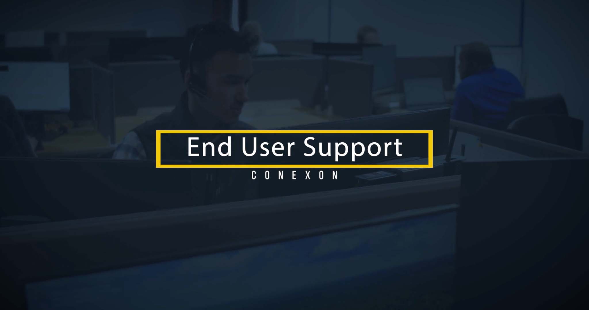 A support worker sits behind a desk, a blue overlay overtop of picture with text that says, "End user support"