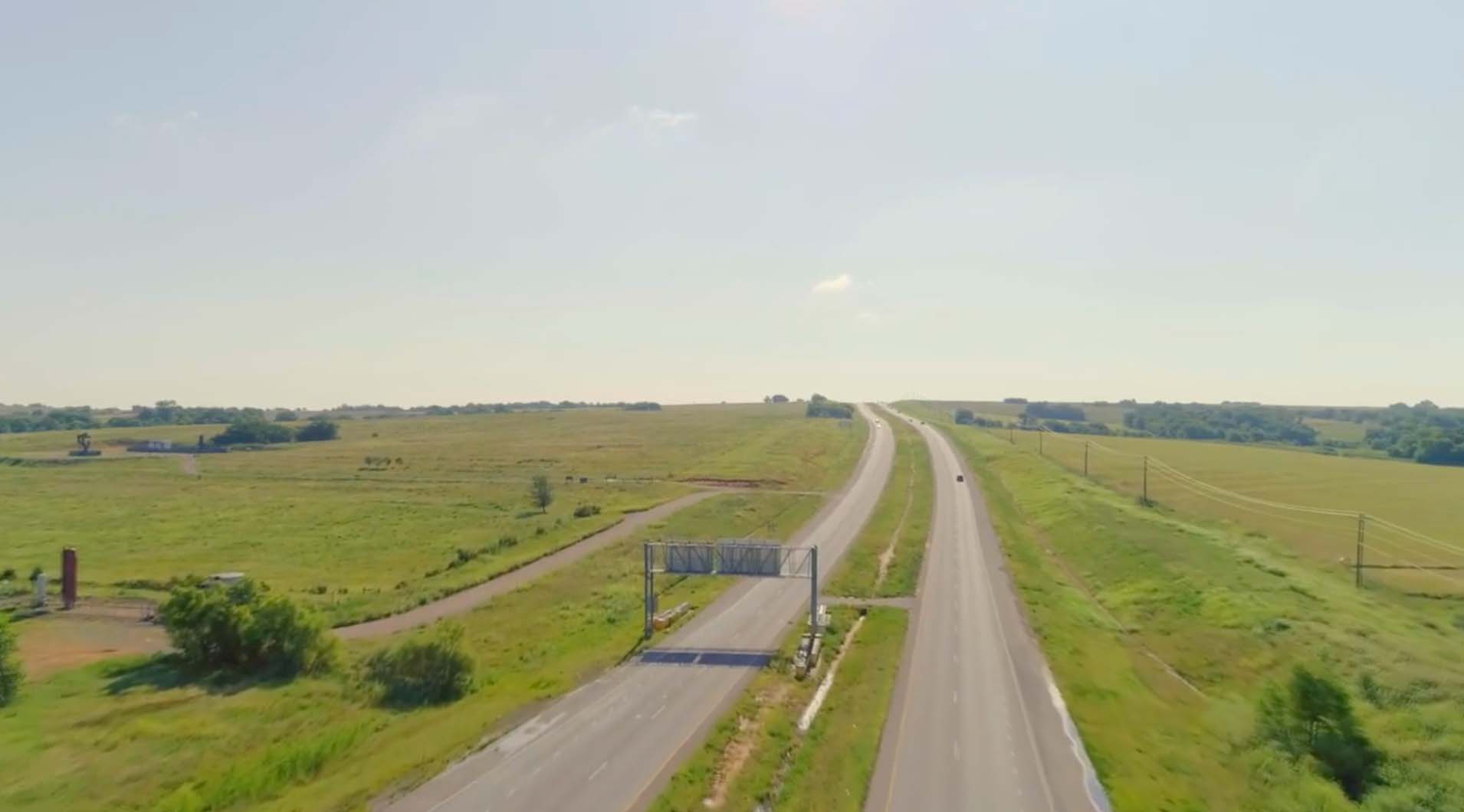Arial view of a four lane highway stretching over the horizon. 