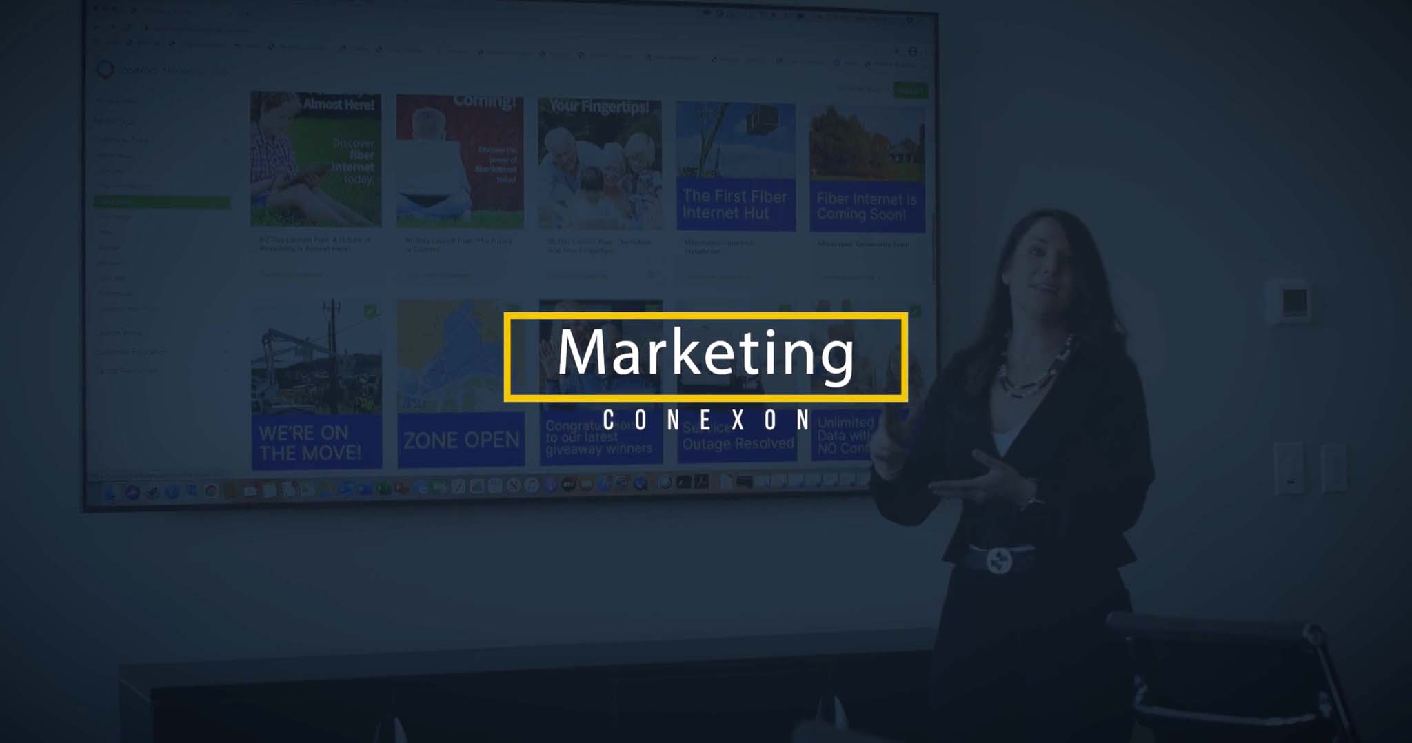 A woman stands next to a projector giving a presentation with a blue overlay overtop of picture with text that says, "Marketing"