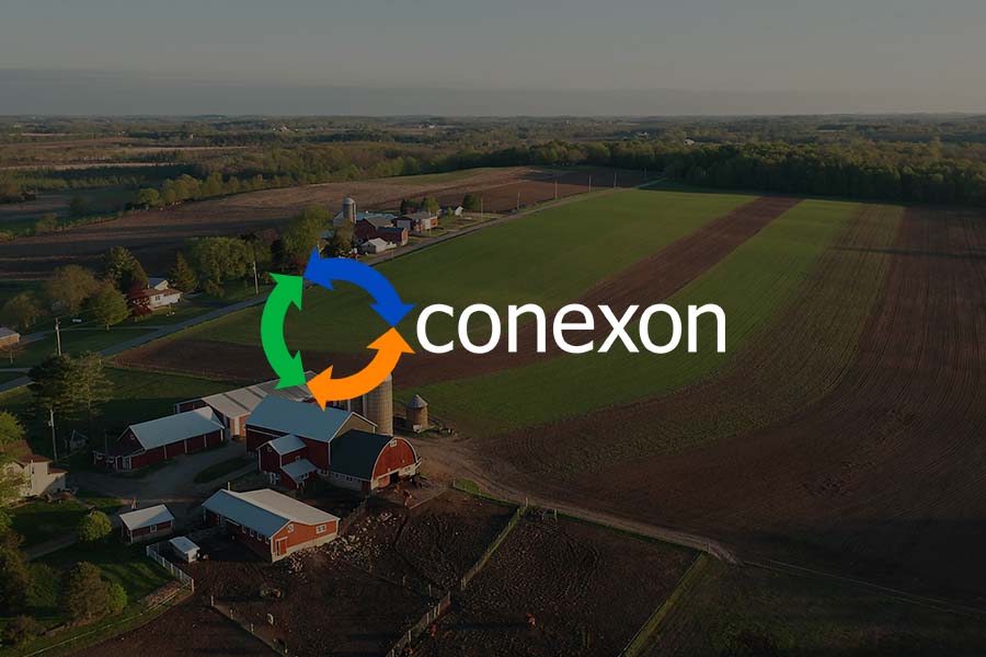 Rural American farmland seen from an arial view at sunrise with the Conexon logo..