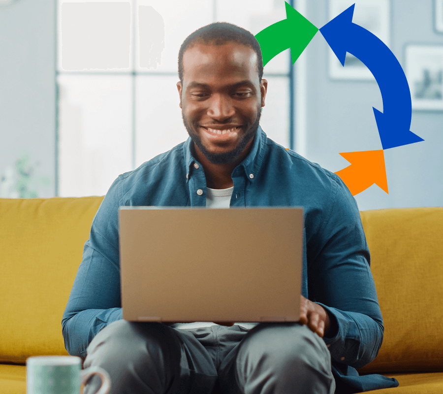 A man sits on a couch and uses his laptop while a conexon icon floats behind his head.